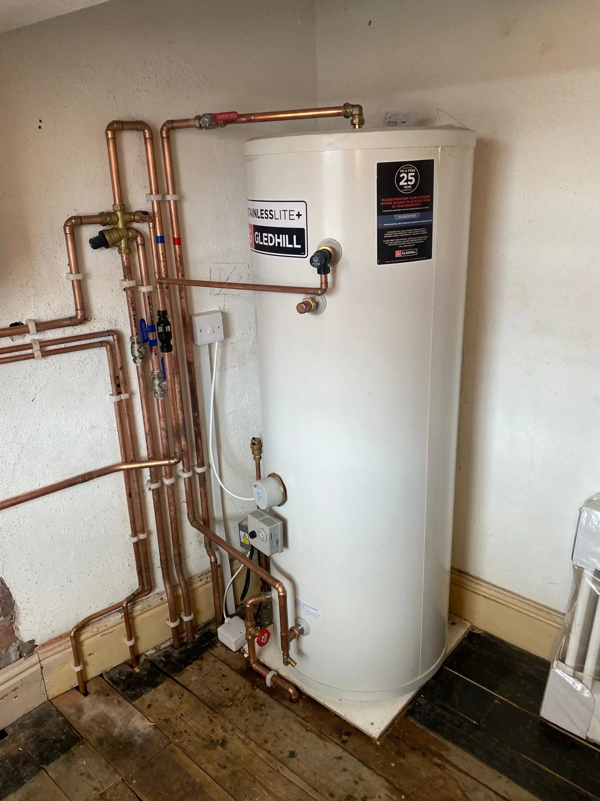 Gledhill hot water cylinder with copper pipework and controls
